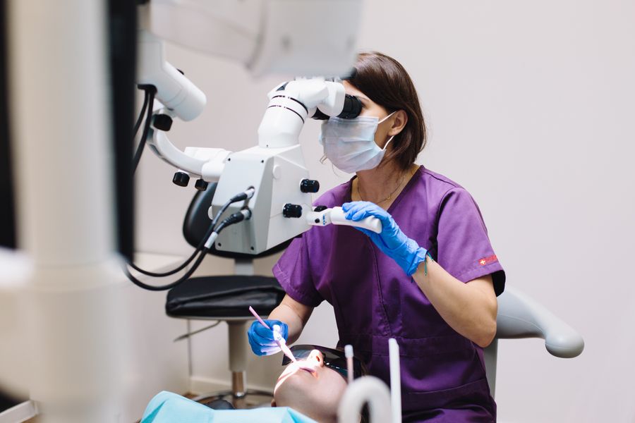 Dentist working with a surgical microscope